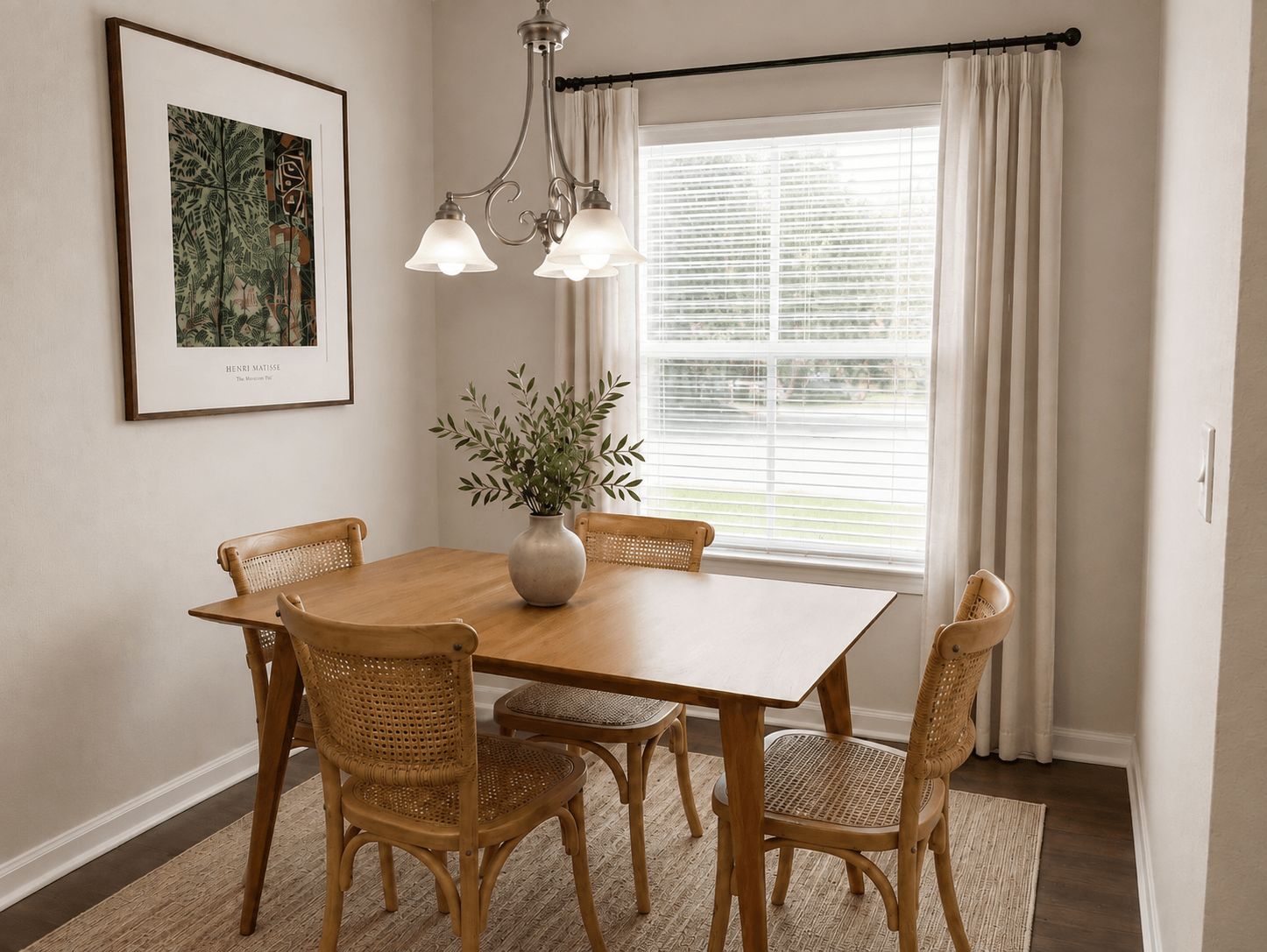 A dining room with a wooden table and chairs.